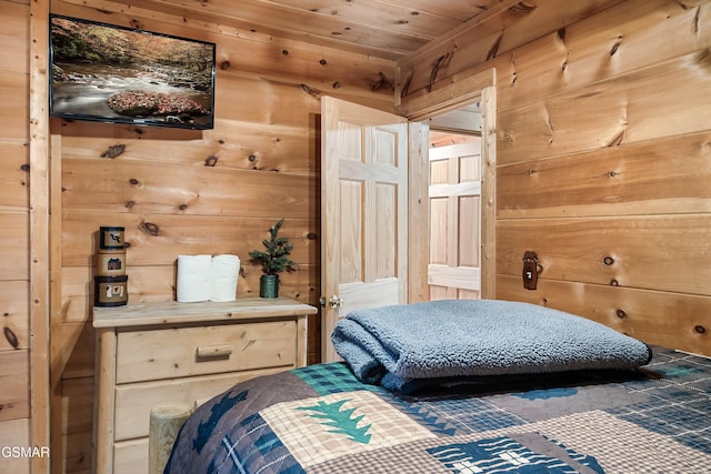 bedroom with wooden walls and wood ceiling