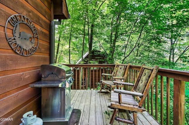 wooden deck featuring a grill