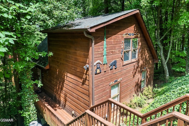 view of property exterior featuring a wooden deck