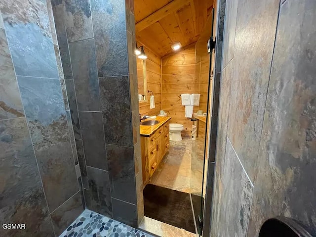 full bath with vanity, a tile shower, toilet, and wooden ceiling