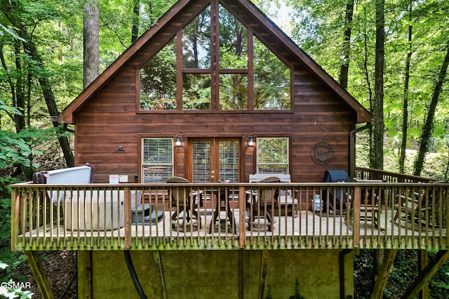 rear view of house featuring a deck