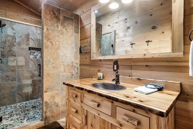 bathroom with vanity, wood walls, lofted ceiling, wooden ceiling, and a tile shower