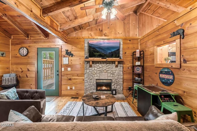 3110 Cove Creek Way, Sevierville, TN 37862 - living area with wooden ceiling, wooden walls, wood-type flooring, a ceiling fan, and a stone fireplace