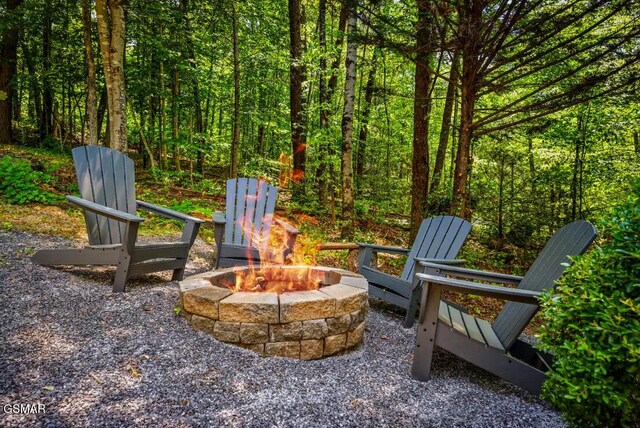 3110 Cove Creek Way, Sevierville, TN 37862 - view of patio featuring an outdoor fire pit and a wooded view