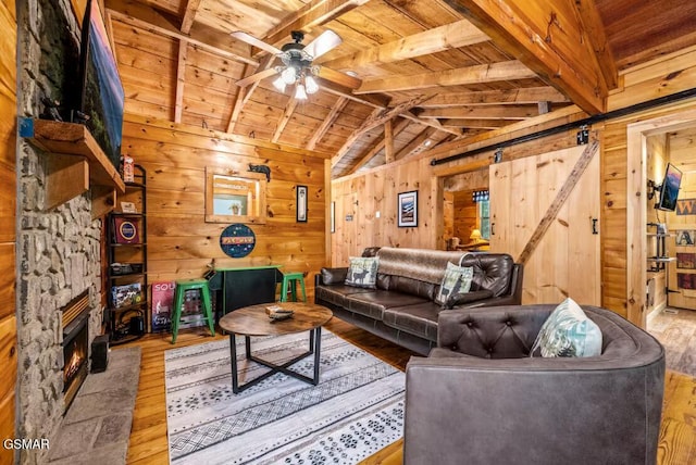 3110 Cove Creek Way, Sevierville, TN 37862 - living area featuring wooden ceiling, hardwood / wood-style floors, a ceiling fan, wooden walls, and a barn door