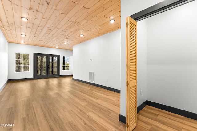 spare room with french doors, wood ceiling, and light hardwood / wood-style flooring