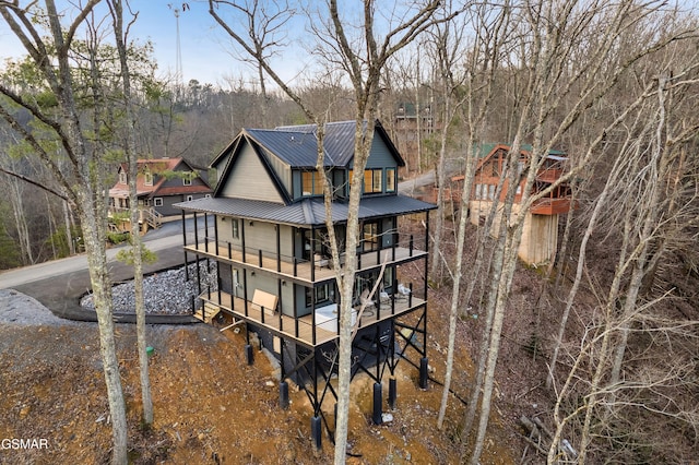 back of property featuring a balcony