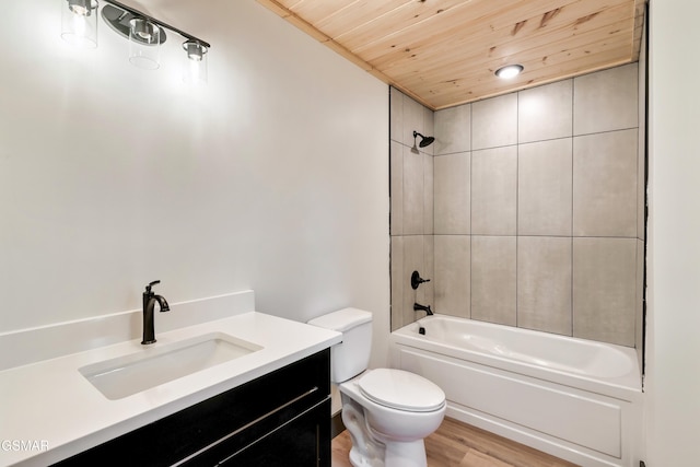 full bathroom with toilet, wooden ceiling, vanity, tiled shower / bath combo, and hardwood / wood-style floors