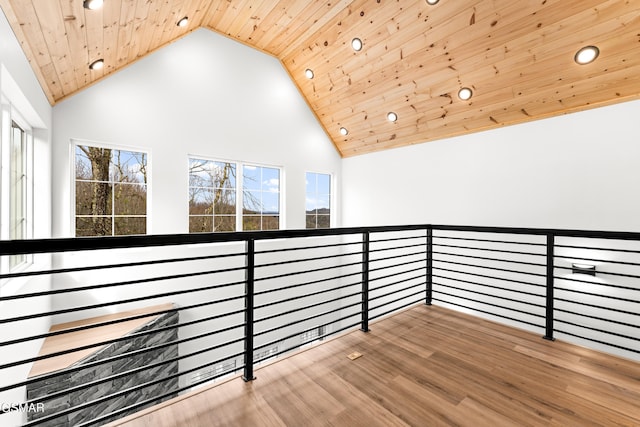 interior space with high vaulted ceiling, hardwood / wood-style floors, and wooden ceiling