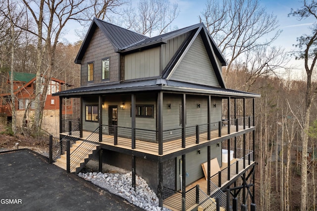 farmhouse featuring a balcony and covered porch