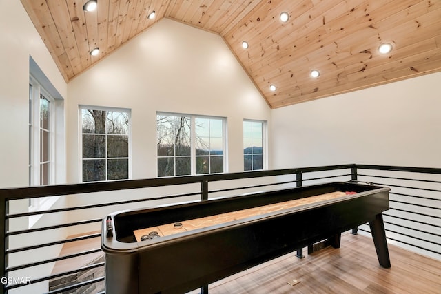 recreation room with wooden ceiling, high vaulted ceiling, and light hardwood / wood-style floors