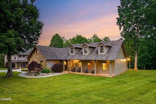 125 Burning Oaks Dr, Sevierville, TN 37876 - view of front facade featuring covered porch, a lawn, a shingled roof, and stone siding