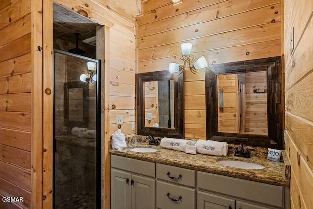 full bathroom featuring wooden walls, a stall shower, and a sink