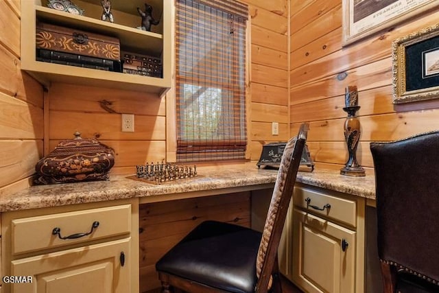 interior space with wooden walls and built in desk