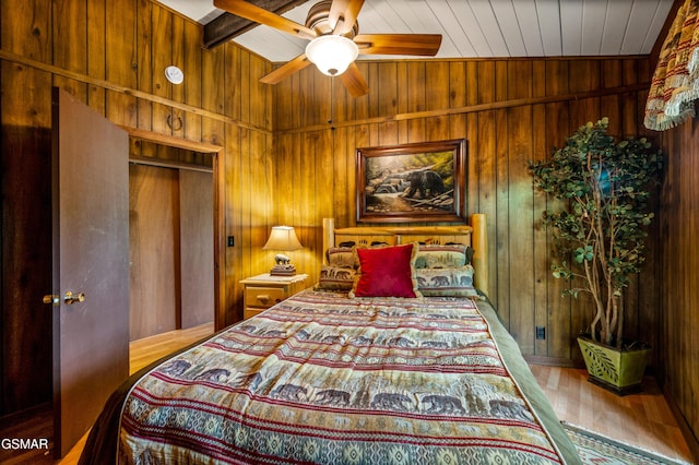 1923 E Arolla Ct, Gatlinburg, TN 37738 - bedroom featuring wooden walls, wood finished floors, ceiling fan, a wood ceiling with exposed beams, and a closet