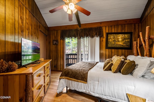 1923 E Arolla Ct, Gatlinburg, TN 37738 - bedroom featuring wooden walls, access to exterior, light wood-style flooring, and beam ceiling