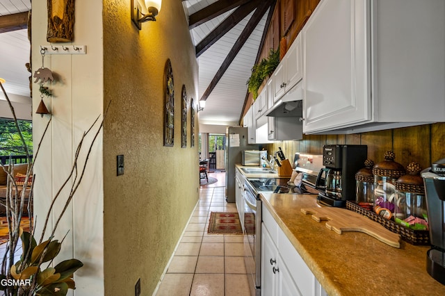 1923 E Arolla Ct, Gatlinburg, TN 37738 - kitchen with stainless steel range with electric stovetop, a textured wall, white cabinetry, light tile patterned floors, and beam ceiling