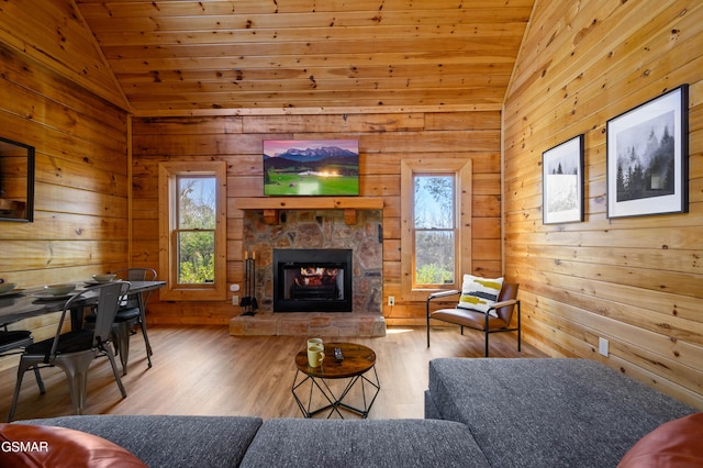 living room with wooden ceiling, lofted ceiling, a fireplace, and wood-type flooring