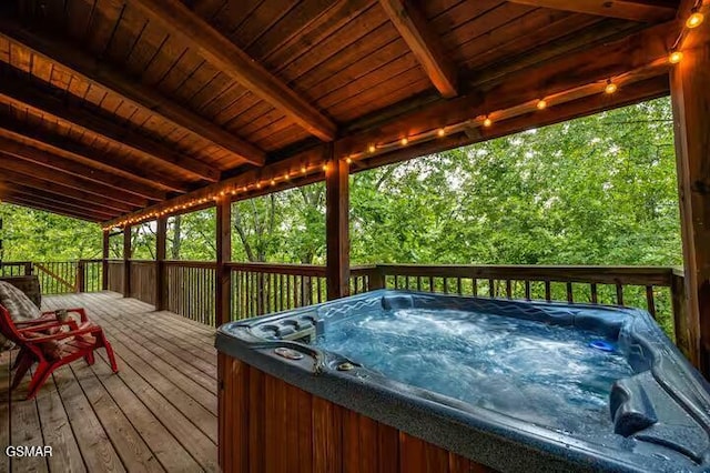 wooden deck featuring a hot tub