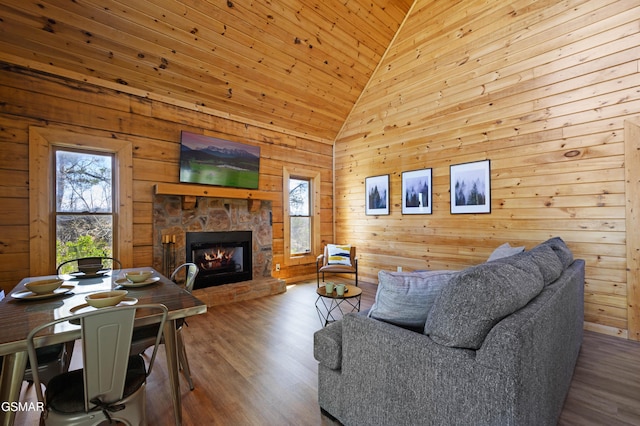 living room with high vaulted ceiling, wooden ceiling, hardwood / wood-style flooring, and a fireplace