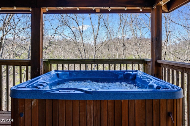 wooden deck with a hot tub