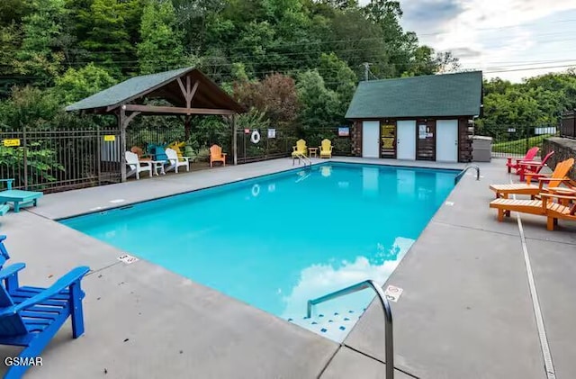 view of pool with a patio area, a gazebo, and an outdoor structure