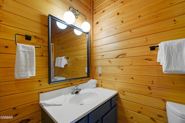 bathroom featuring vanity and wooden walls