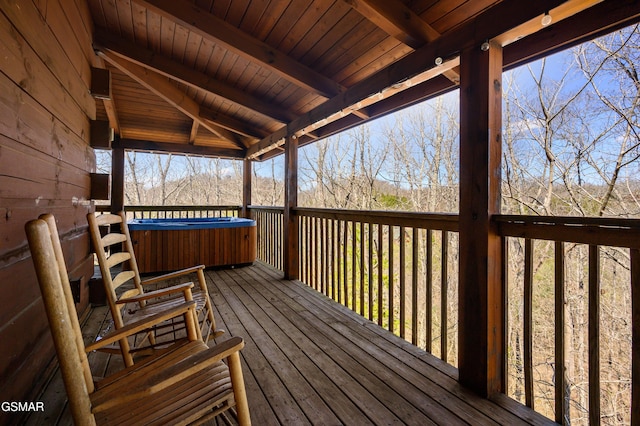 wooden deck with a hot tub