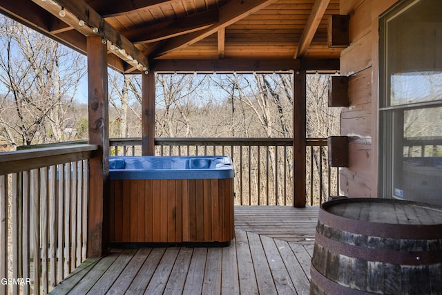 wooden deck with a hot tub