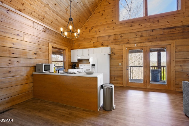 kitchen with white appliances, white cabinetry, hanging light fixtures, high vaulted ceiling, and wooden ceiling