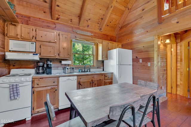 kitchen with a sink, under cabinet range hood, white appliances, wood ceiling, and vaulted ceiling with beams