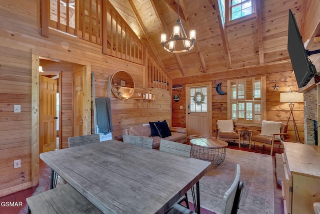 dining room featuring wooden walls, a healthy amount of sunlight, wooden ceiling, and beamed ceiling