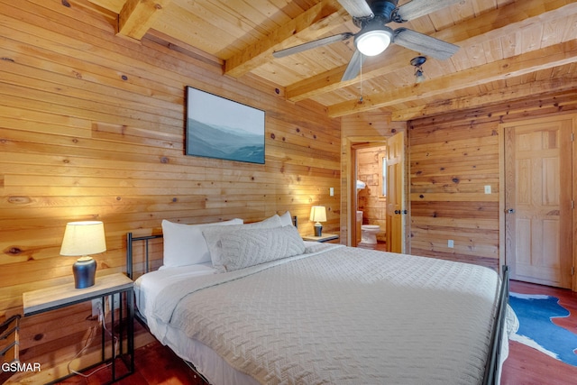 bedroom with wooden walls, ceiling fan, wood ceiling, beam ceiling, and ensuite bath