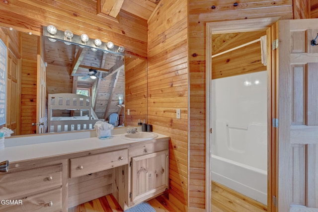 full bath with vanity, wood finished floors, wooden walls, and wood ceiling