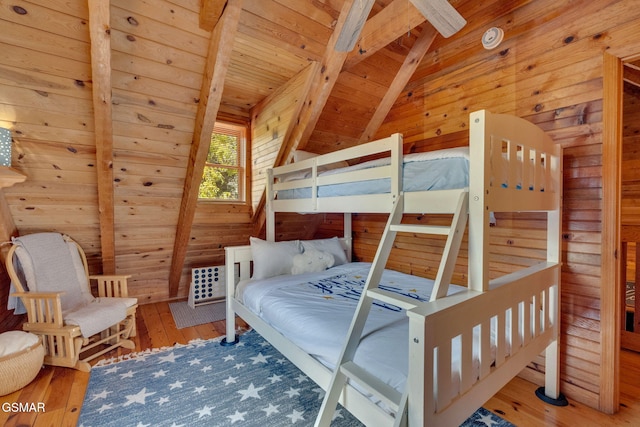 bedroom featuring wooden walls, wooden ceiling, lofted ceiling with beams, and wood-type flooring