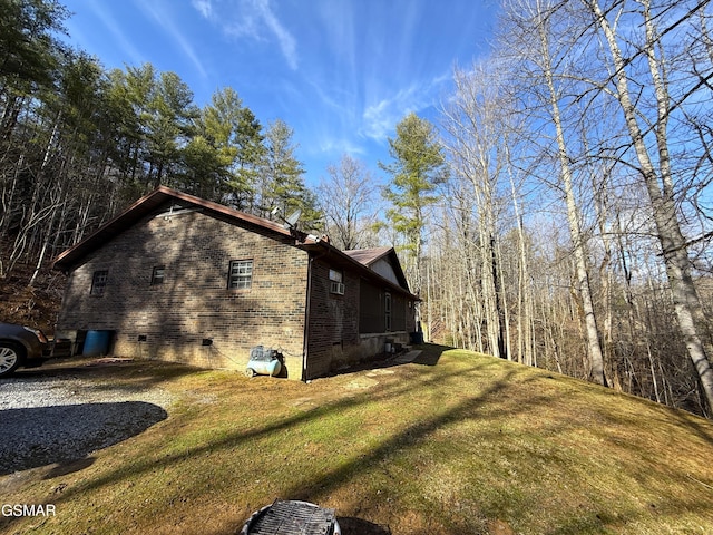 view of side of property with a lawn