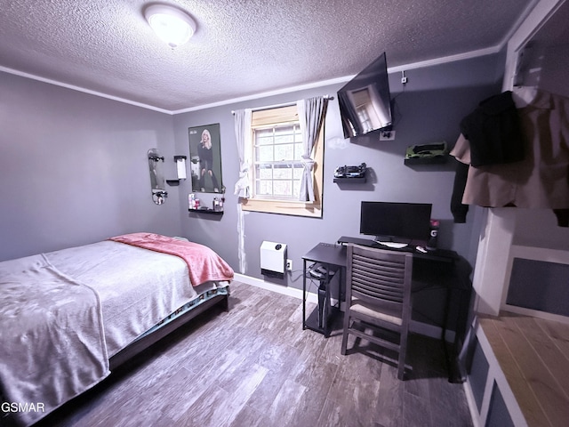 bedroom with hardwood / wood-style floors and a textured ceiling