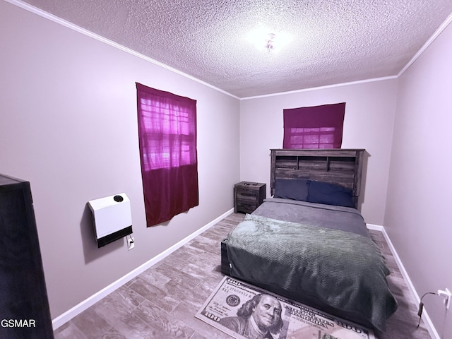 bedroom featuring ornamental molding, hardwood / wood-style floors, heating unit, and a textured ceiling