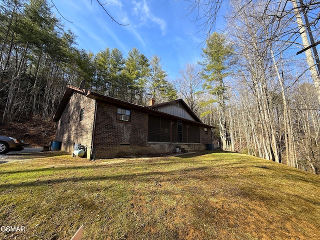 view of side of property featuring a yard and a sunroom