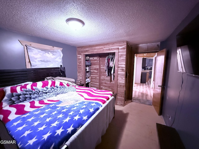 bedroom with a closet, carpet floors, and a textured ceiling