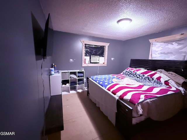 bedroom with cooling unit and a textured ceiling