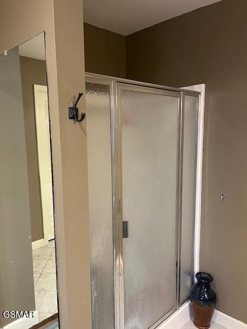 bathroom with tile patterned floors and an enclosed shower