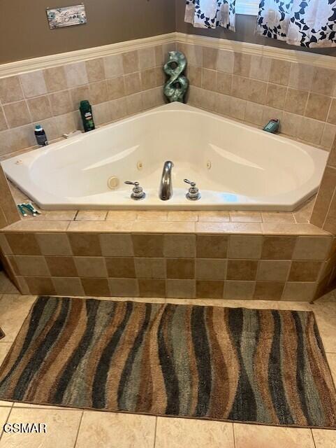 bathroom featuring tile patterned floors and tiled bath