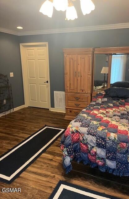 bedroom featuring dark wood-type flooring and ornamental molding