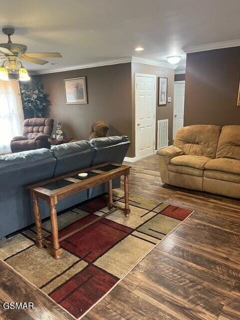 living room with ceiling fan, dark wood-type flooring, and ornamental molding