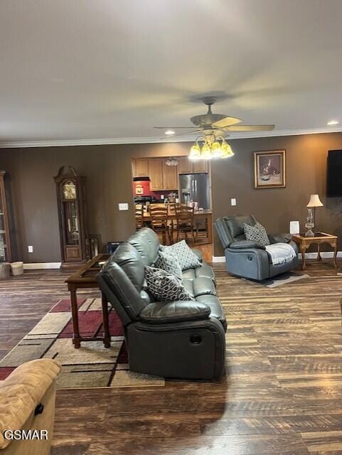 living room featuring ceiling fan, hardwood / wood-style flooring, and ornamental molding