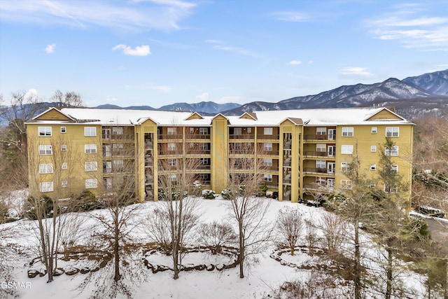 snow covered property featuring a mountain view