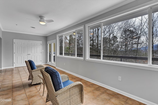 sunroom / solarium featuring a wealth of natural light and ceiling fan