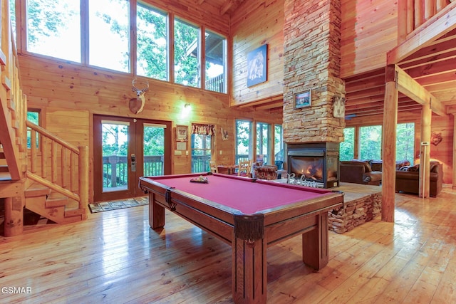 1707 Ridgecrest Dr, Sevierville, TN 37876 - recreation room featuring a high ceiling, french doors, plenty of natural light, wooden walls, and a fireplace