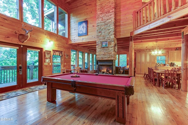1707 Ridgecrest Dr, Sevierville, TN 37876 - recreation room with a high ceiling, pool table, wooden walls, light wood-style flooring, and plenty of natural light